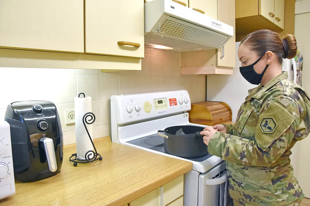Soldier cooking in a renovated apartment kitchen