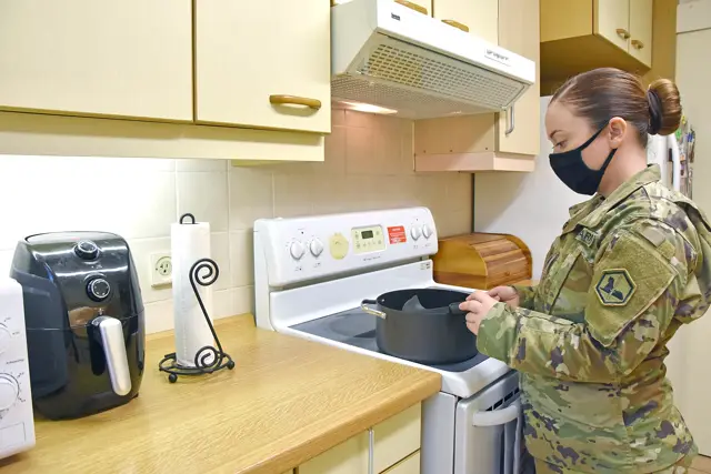 Soldier cooking in a newly renovated apartment kitchen
